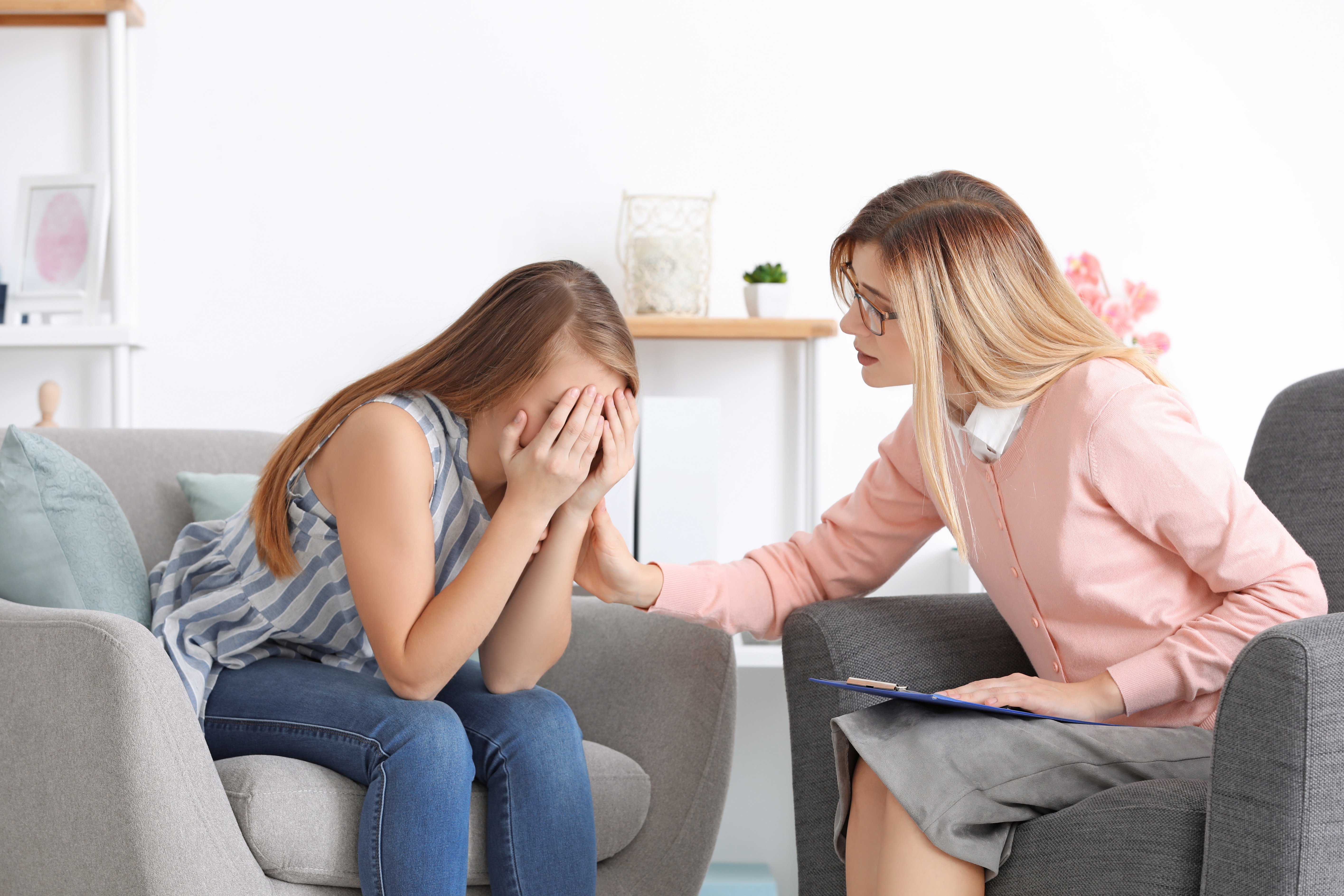 Upset Young Woman at Psychologist's Office